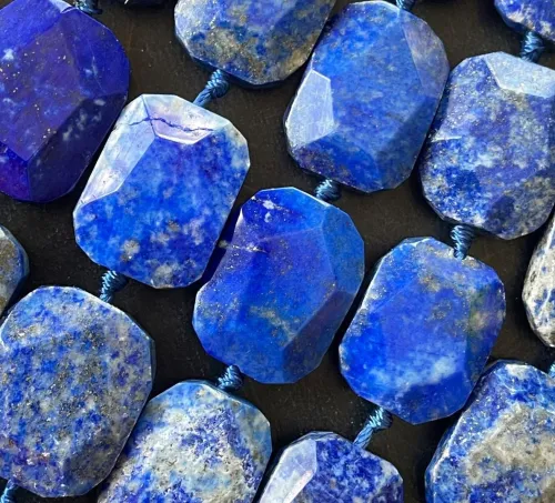Lapis lazuli jewelry pieces alongside raw mineral specimens